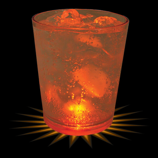 A customizable plastic rocks cup filled with ice and liquid with an orange LED light in it.