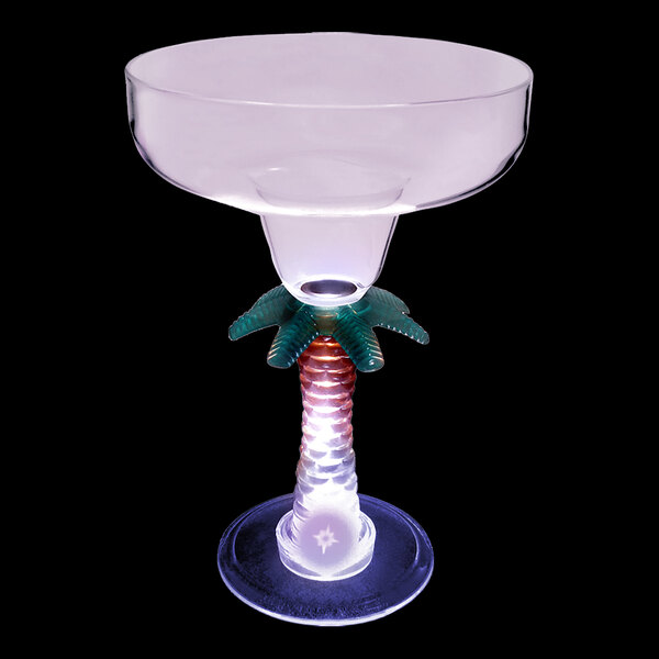 A clear plastic margarita cup with a palm tree stem and a purple LED light.