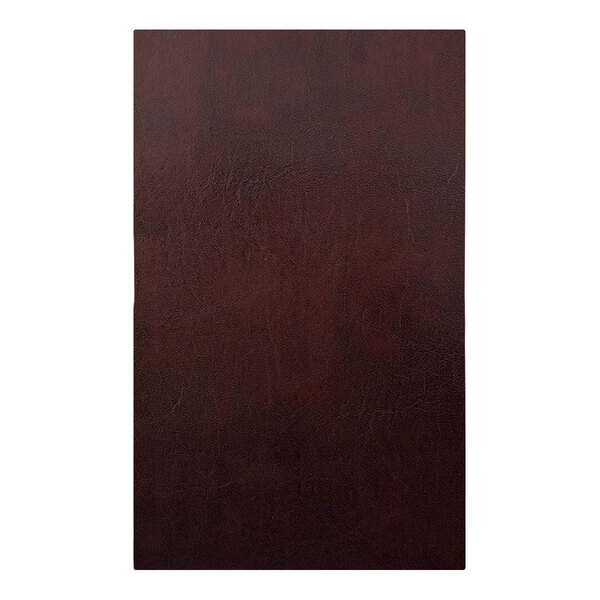A close-up of a brown leather surface with picture corners.