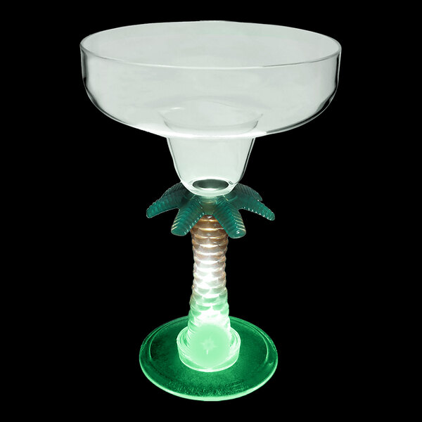 A clear plastic margarita glass with a palm tree stem and green LED light.