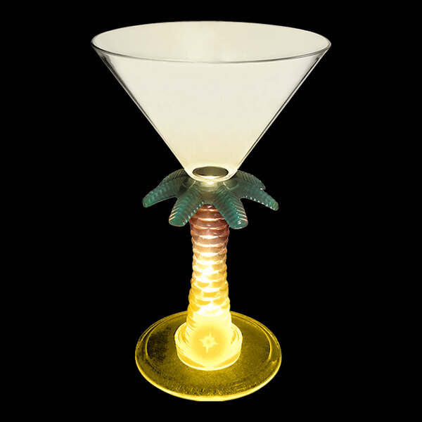 A white plastic martini glass with a palm tree stem and a yellow LED light.