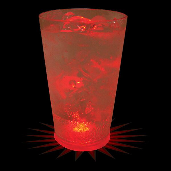 A close-up of a 16 oz. plastic pint cup with a red LED light and a red drink with ice.
