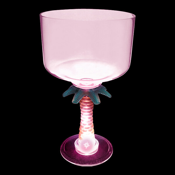 A white plastic palm tree margarita cup with a pink LED light and a star-shaped base.