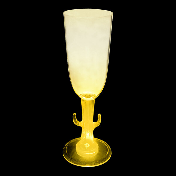 A yellow plastic champagne cup with a cactus stem and a yellow LED light.