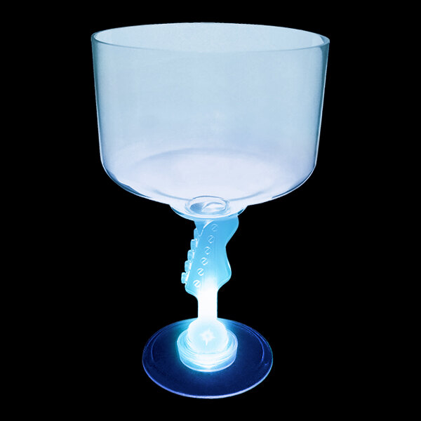 A close-up of a clear plastic guitar stem margarita cup with a blue LED light inside.