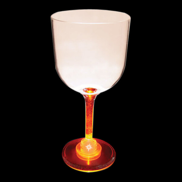 A close-up of a 14 oz. plastic goblet with a red lighted base.
