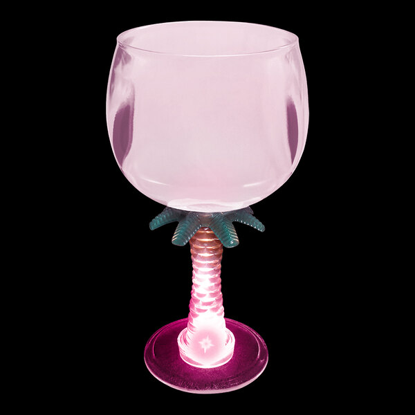 A customizable plastic stem goblet with a lighted up palm tree on it.