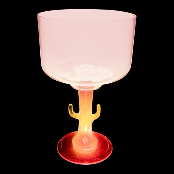 A pink plastic margarita cup with a cactus shaped stem and a red LED light.