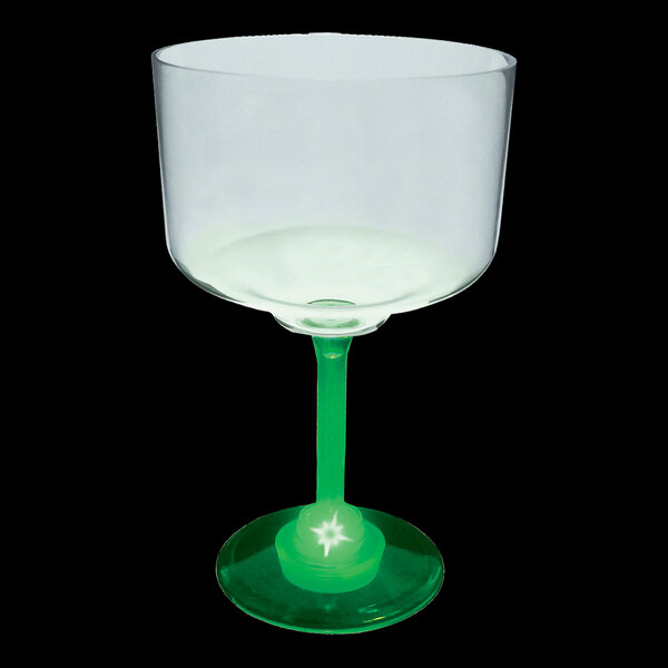 A clear plastic margarita cup with a green base.
