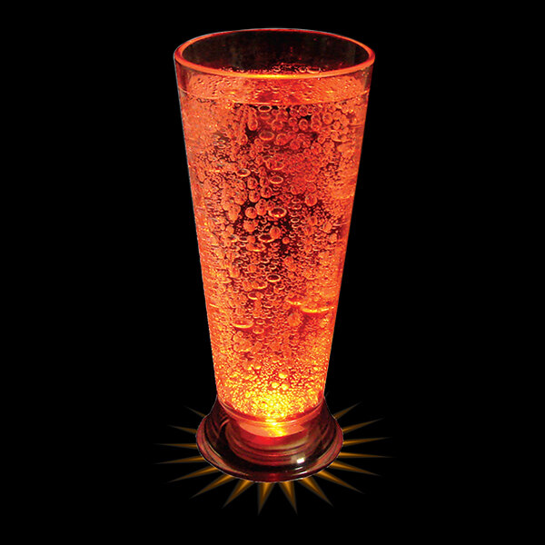 A customizable plastic pilsner cup with an orange LED light filled with a drink.