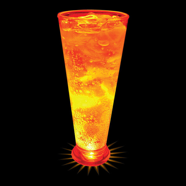 A close-up of a 16 oz. plastic pilsner cup filled with orange liquid and ice with an orange LED light.