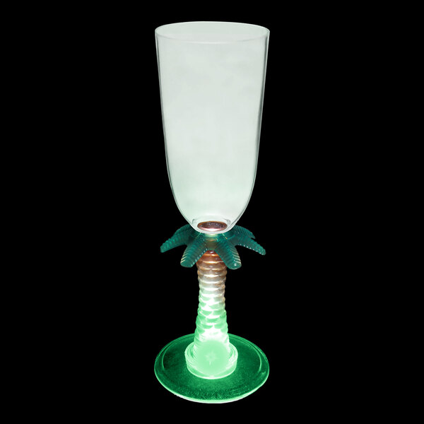 A customizable plastic champagne cup with a green palm tree stem and a green and white base with a green light inside.