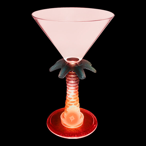 A pink plastic martini glass with a palm tree stem and a red LED light.