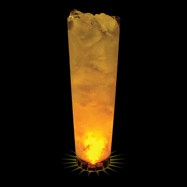 A 32 oz. plastic cup with a yellow LED light inside filled with a yellow liquid and ice.