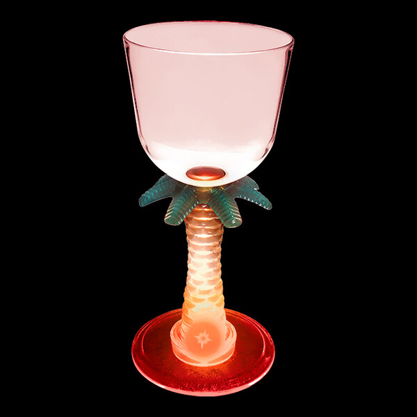 A clear plastic wine cup with a palm tree stem and a red LED light.