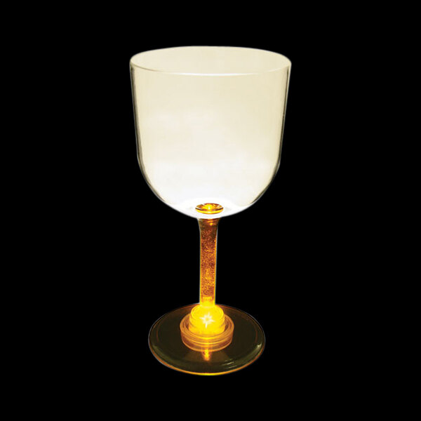 A close-up of a 14 oz. plastic goblet with a yellow light on it.