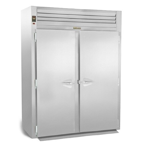A Traulsen roll-in freezer with two white doors.
