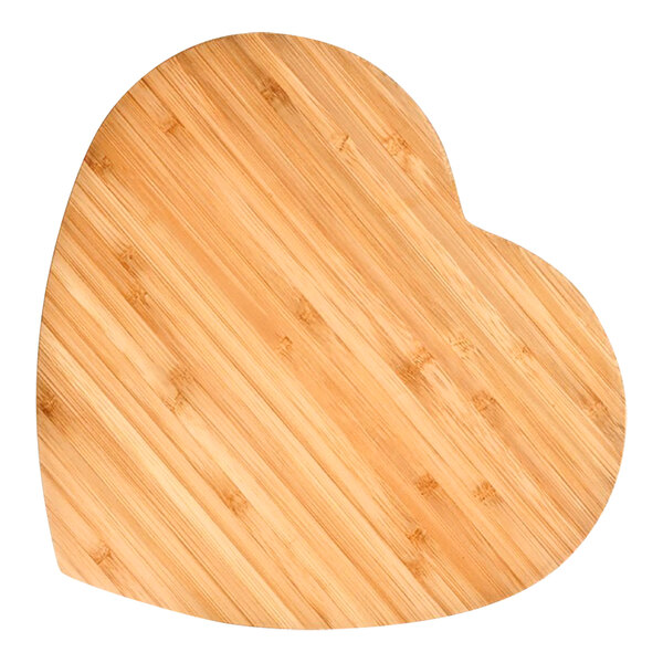 A heart-shaped bamboo cutting board on a table.