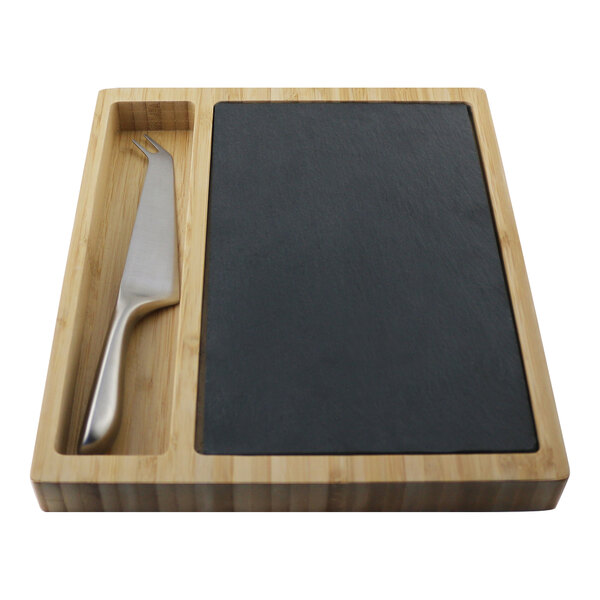 A rectangular acacia cheese board with a slate insert and a stainless steel knife.