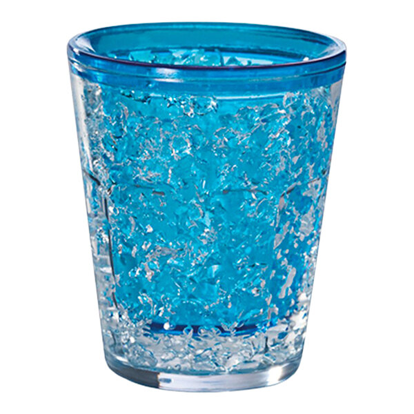 A clear shot glass with blue freezer gel inside.