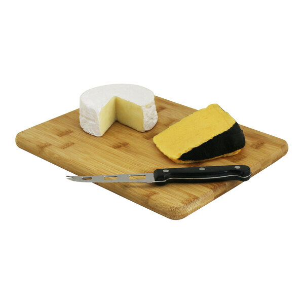 A piece of cheese and a knife on a Franmara bamboo cheese board.