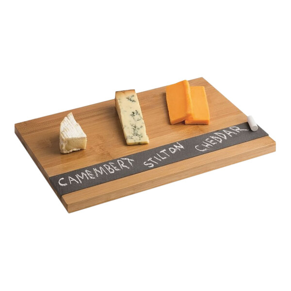 A Franmara bamboo cheese board with slate inlay holding different types of cheese on a wooden surface.