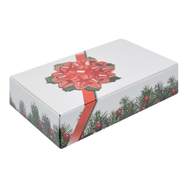 A white box with a red bow and green branches.