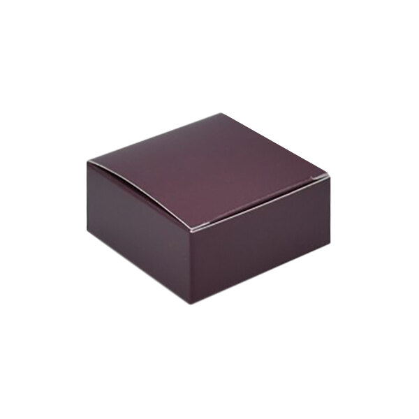 A maroon candy box with a white lid.