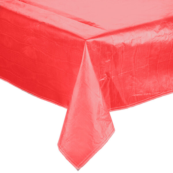 A red vinyl table cover with flannel back on a white table.