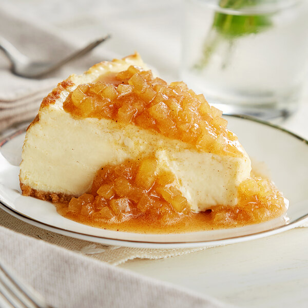 A slice of cheesecake with Oregon Fruit In Hand Apple Harvest Filling & Topping on a plate.