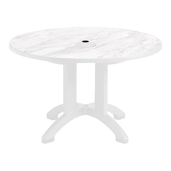 A Grosfillex white resin table with a circular top and white legs.