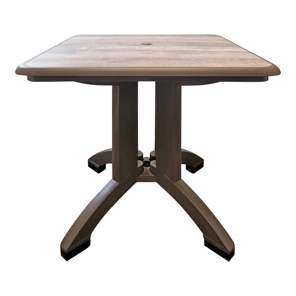 A Grosfillex ranch resin table with bronze legs.