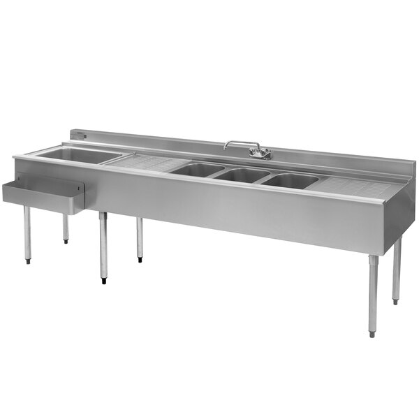 An Eagle Group stainless steel underbar sink with three sinks, two drainboards, and a faucet on the left.