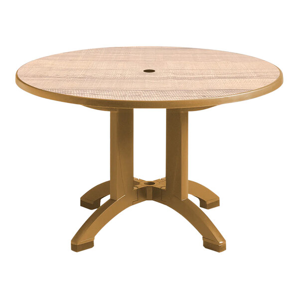 A Grosfillex round resin table with teakwood legs.