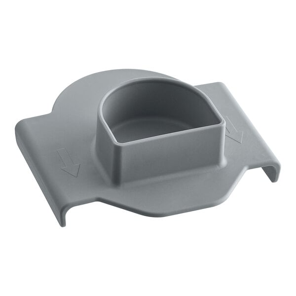 A grey plastic safety pusher with a hole.