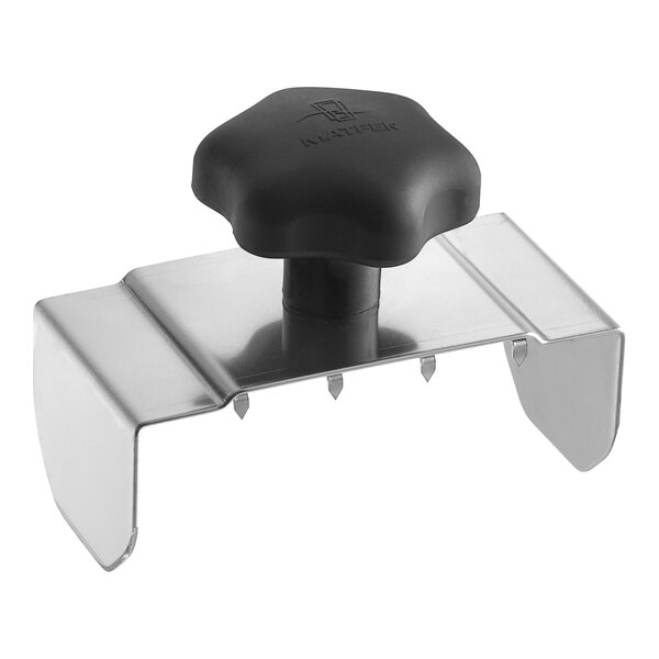 A black plastic object with a black rubber cap on a metal stand.