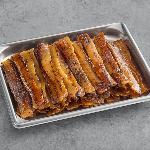 Umaro Plant-Based Vegan Black Pepper Bacon strips on a metal tray.