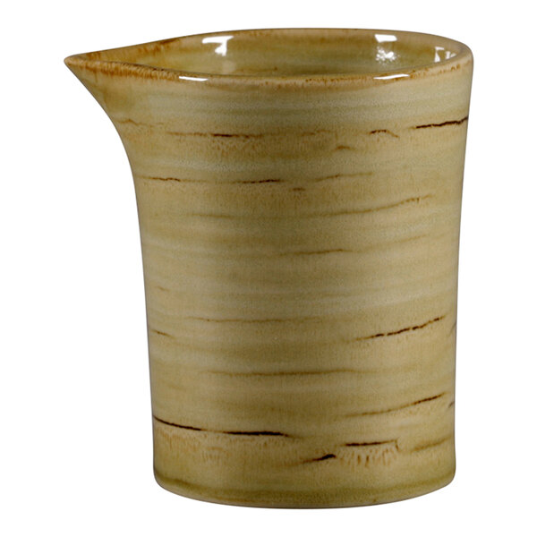 A garnet RAK Porcelain cream jug with a handle.