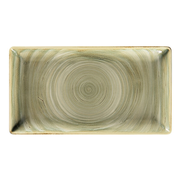 A close-up of a RAK Porcelain rectangular plate with a circular emerald pattern.
