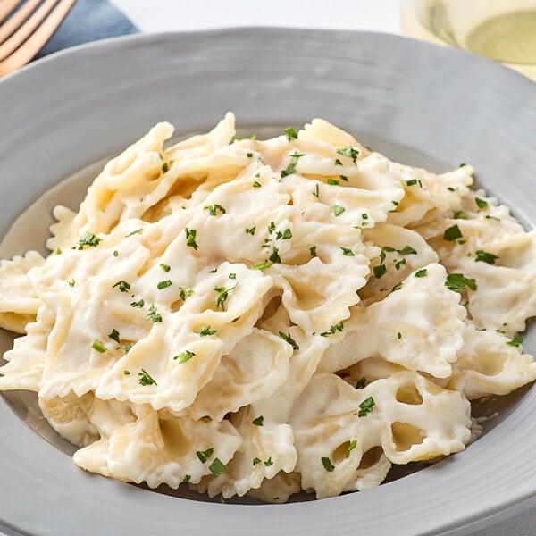 A plate of pasta with Foothill Farms Alfredo sauce and parsley.
