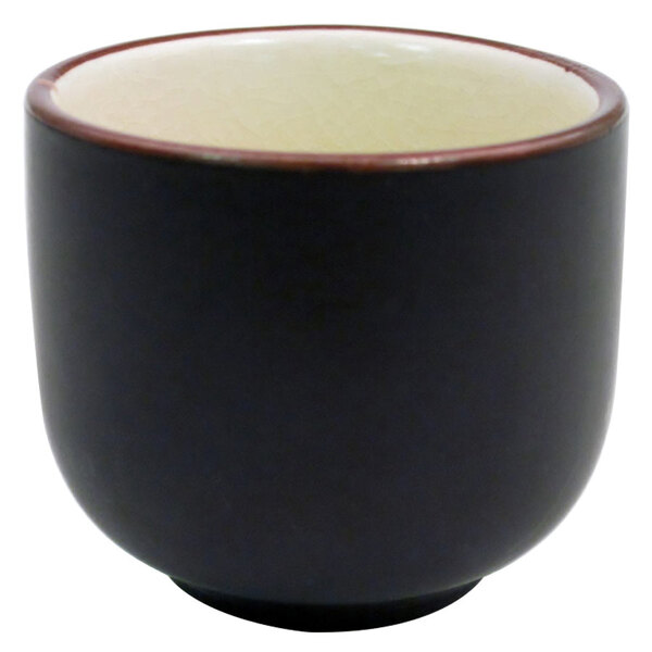 A black and creamy white Japanese style sake cup.