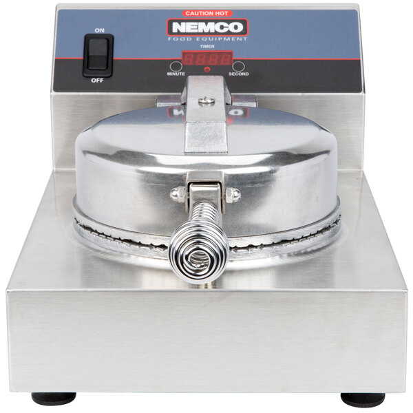 A Nemco Waffle Cone Maker on a counter with a round metal lid.
