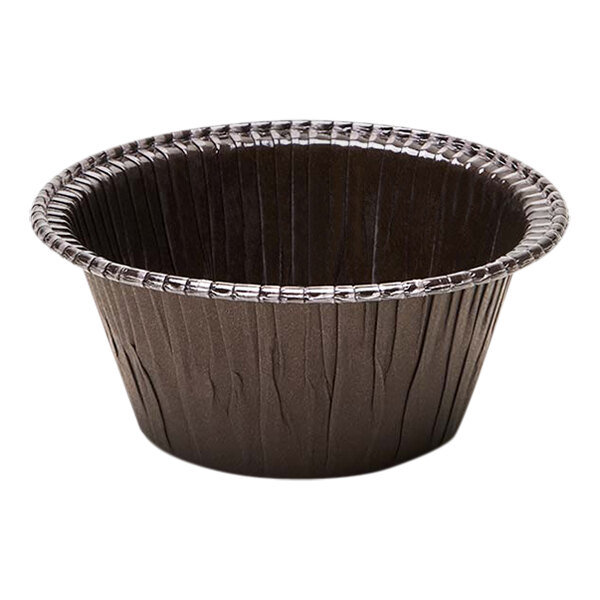 A brown paper baking mold with fluted sides.
