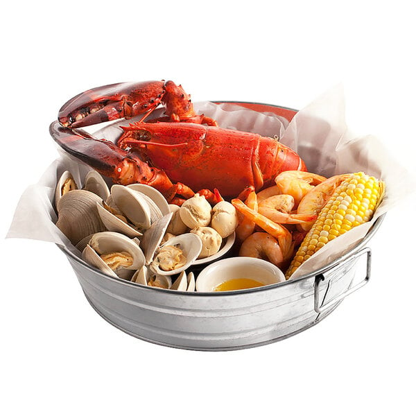 An American Metalcraft galvanized metal bucket filled with seafood, corn, and lobster.