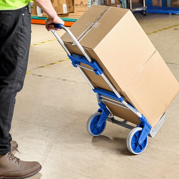 A person pushing a Lavex hand truck with a box.