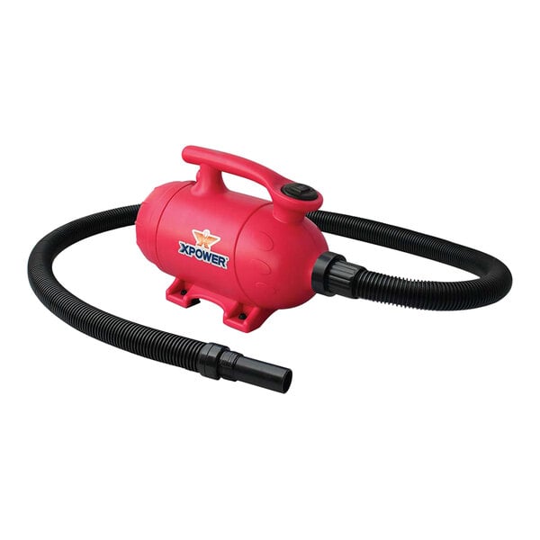 A pink XPOWER pet vacuum with a black hose.