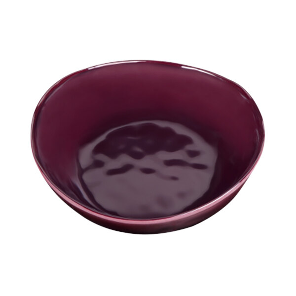 A purple Elite Global Solutions melamine bowl with a small amount of liquid in it.
