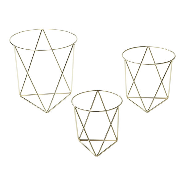 A set of three gold metal geometric pizza stands.