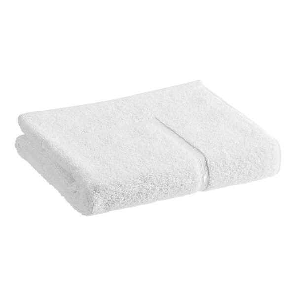 A folded white 1888 Mills True Comfort bath mat on a white background.