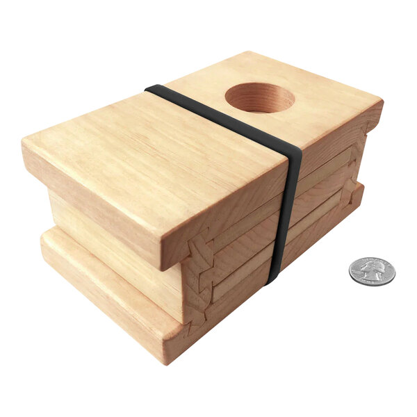 A wooden box with a wooden block with a hole in it on top.